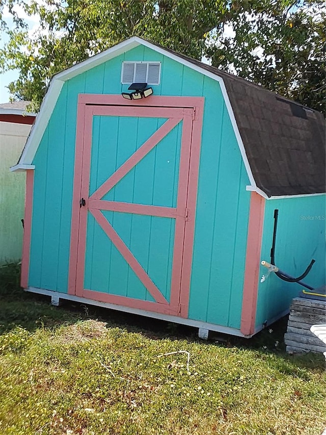 view of outbuilding featuring a yard