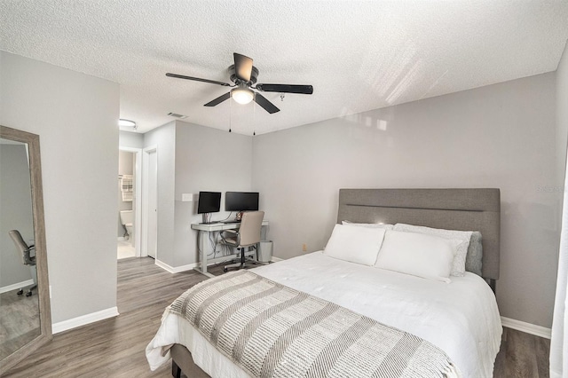 bedroom featuring a textured ceiling, a ceiling fan, visible vents, baseboards, and dark wood-style floors