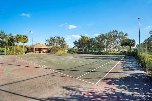 view of tennis court with fence