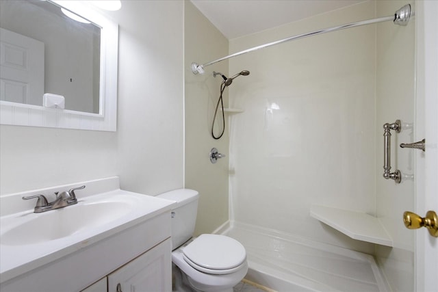 bathroom with a shower, vanity, and toilet