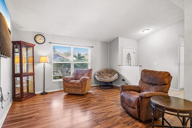 sitting room featuring a textured ceiling and light wood-type flooring