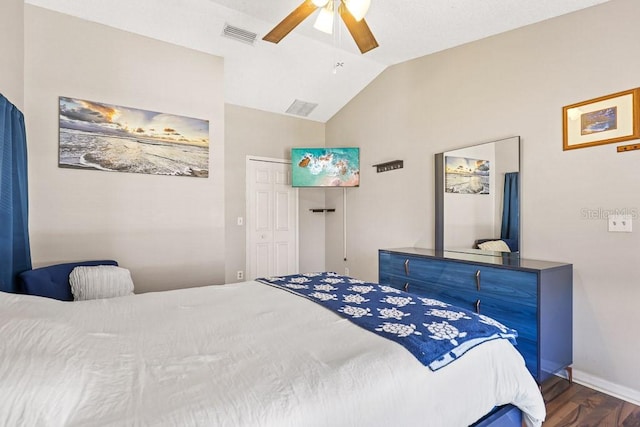 bedroom featuring ceiling fan, a closet, dark hardwood / wood-style flooring, and vaulted ceiling