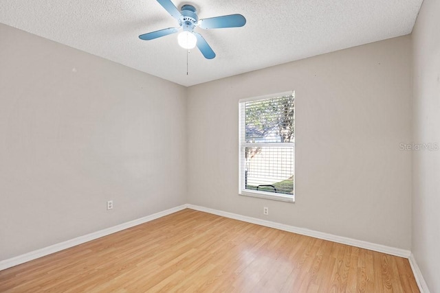 spare room with ceiling fan, light wood-type flooring, and a textured ceiling