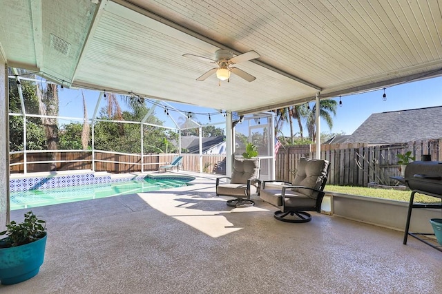 view of patio with ceiling fan and a fenced in pool