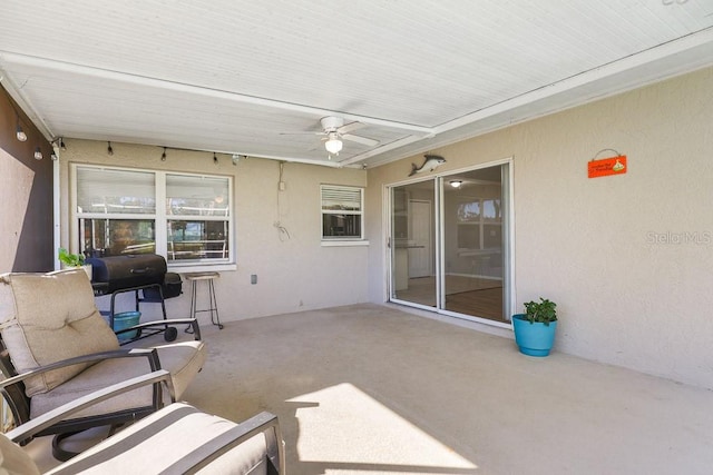 sunroom featuring ceiling fan