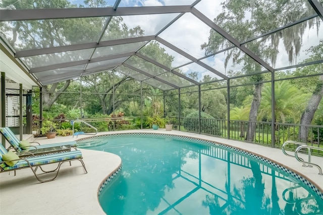 view of swimming pool with a lanai and a patio