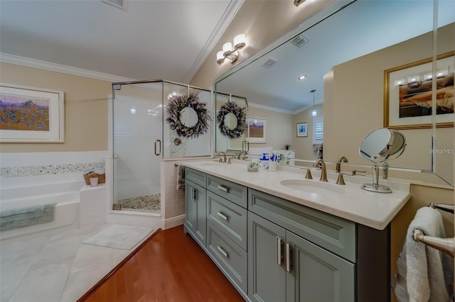 bathroom with lofted ceiling, hardwood / wood-style floors, ornamental molding, separate shower and tub, and vanity