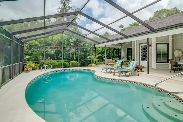 view of swimming pool featuring a lanai, ceiling fan, and a patio