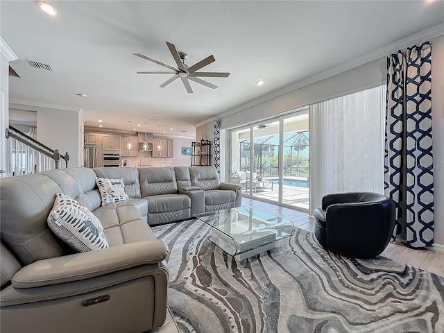 living room with ceiling fan, ornamental molding, and light hardwood / wood-style flooring