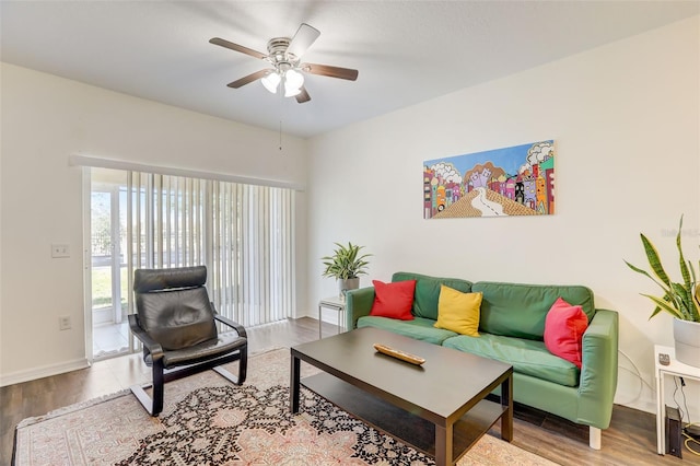 living room featuring wood-type flooring and ceiling fan