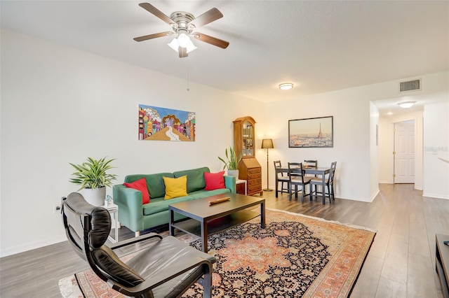 living room with hardwood / wood-style flooring and ceiling fan