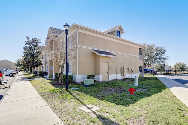 view of home's exterior with a yard