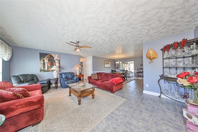 living room featuring ceiling fan with notable chandelier, a textured ceiling, and tile patterned floors