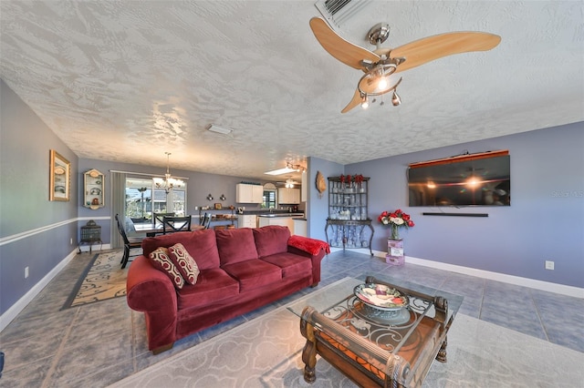 tiled living room featuring a chandelier and a textured ceiling