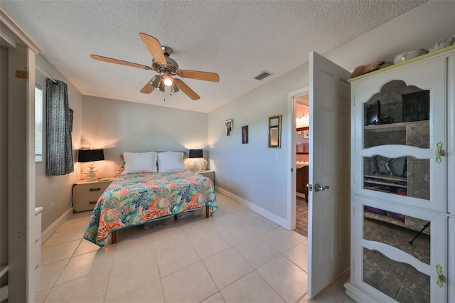 bedroom featuring light tile patterned floors, a textured ceiling, and ceiling fan