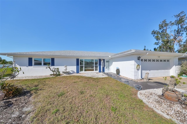 ranch-style home with a front yard and a garage