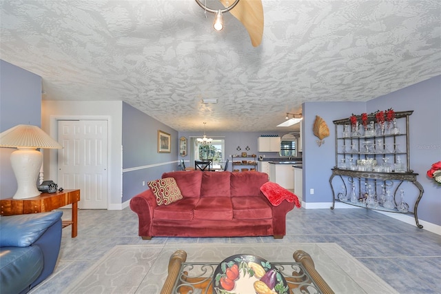 tiled living room featuring a textured ceiling