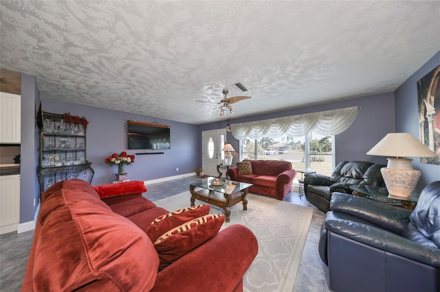 tiled living room featuring a textured ceiling and ceiling fan