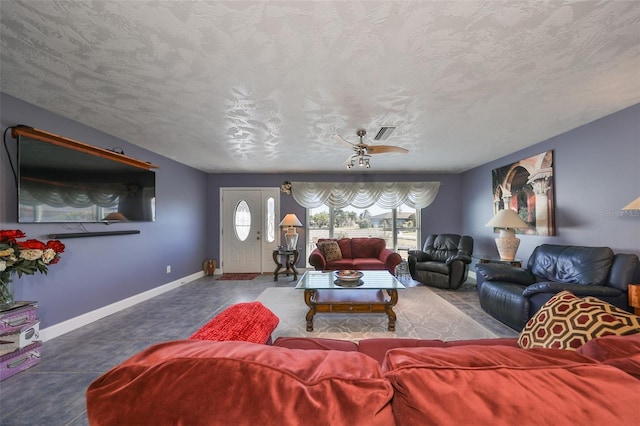 tiled living room featuring a textured ceiling and ceiling fan