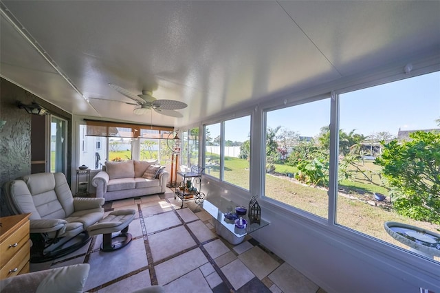 sunroom / solarium featuring plenty of natural light and ceiling fan