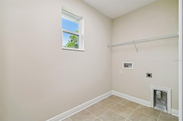 58251/2 S 5th St, Tampa, FL 33611 - laundry area with electric dryer hookup, hookup for a washing machine, light tile patterned floors, and baseboards