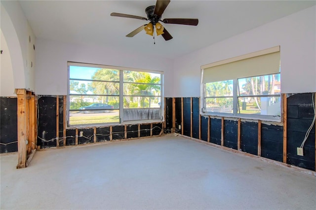 unfurnished room featuring ceiling fan and a healthy amount of sunlight