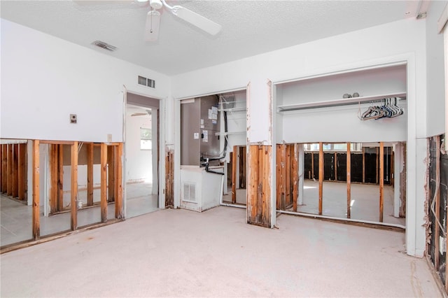 interior space with ceiling fan and a textured ceiling