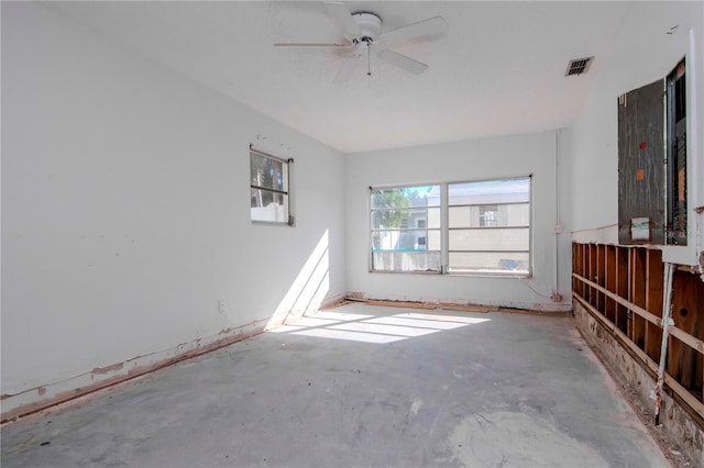 unfurnished living room with ceiling fan and concrete floors