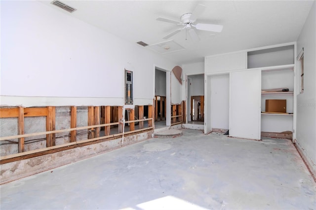 interior space with ceiling fan and concrete flooring