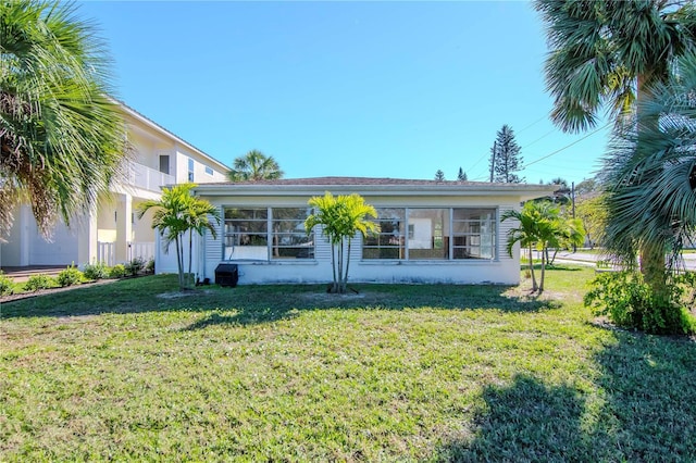 rear view of property with a lawn