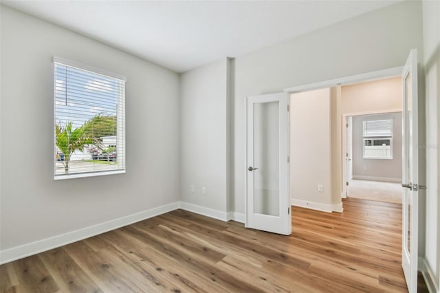 unfurnished bedroom featuring light wood-style flooring and baseboards