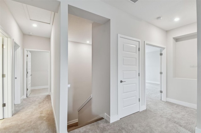 corridor featuring recessed lighting, attic access, carpet flooring, an upstairs landing, and baseboards