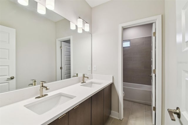 bathroom with tile patterned flooring, a sink, toilet, and double vanity