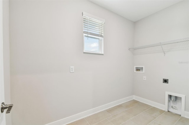 laundry area with washer hookup, light tile patterned flooring, electric dryer hookup, laundry area, and baseboards