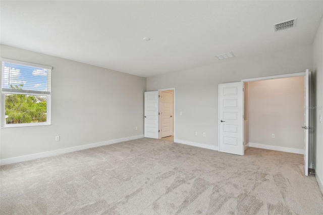 unfurnished bedroom featuring carpet floors, visible vents, and baseboards