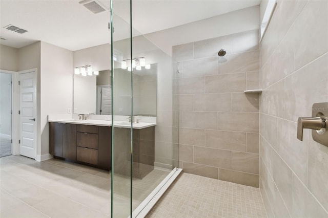 bathroom with tile patterned floors, visible vents, walk in shower, and vanity