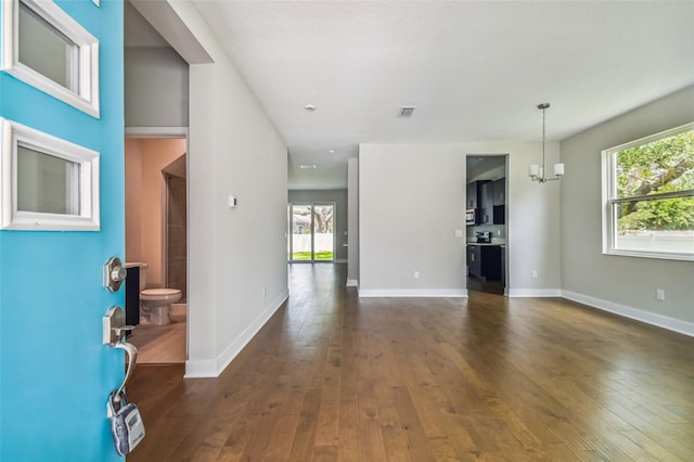 entrance foyer featuring a chandelier and dark wood-type flooring