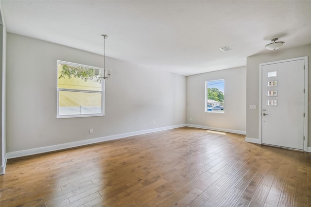 foyer featuring hardwood / wood-style floors and a notable chandelier