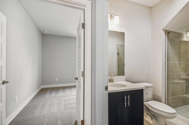 bathroom with vanity, toilet, and a shower with shower door