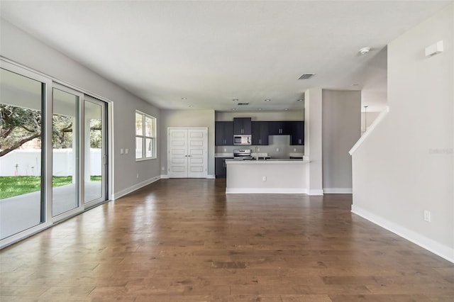 unfurnished living room featuring dark hardwood / wood-style flooring and sink