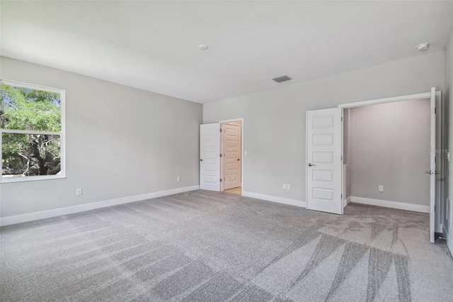 unfurnished bedroom featuring light colored carpet