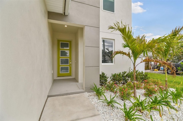 entrance to property featuring stucco siding