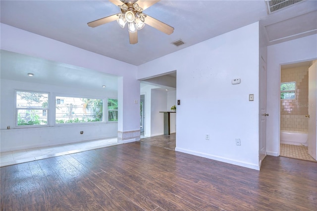 spare room featuring ceiling fan and dark wood-type flooring