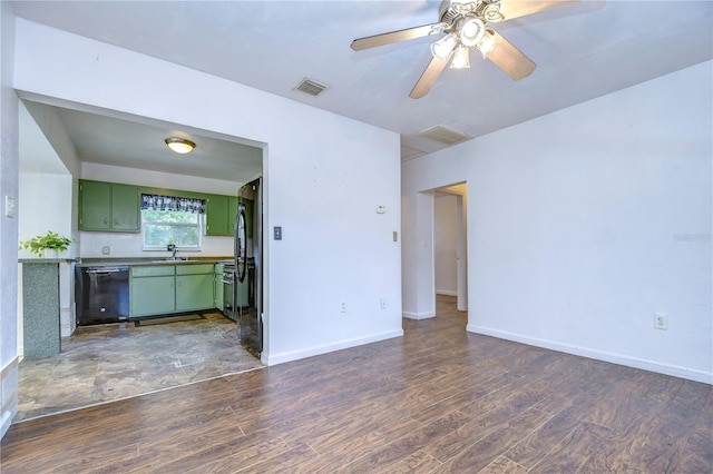 unfurnished living room with ceiling fan, sink, and dark wood-type flooring