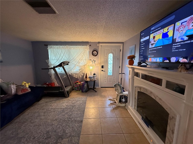 living room featuring tile patterned floors and a textured ceiling