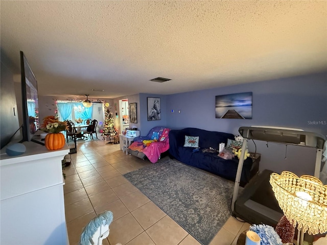 living room featuring tile patterned flooring and a textured ceiling