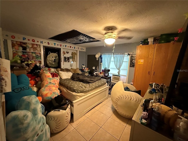 bedroom with light tile patterned floors, a textured ceiling, and ceiling fan