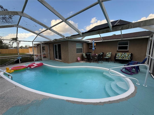 view of swimming pool featuring a lanai and a patio