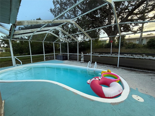 view of swimming pool with a lanai