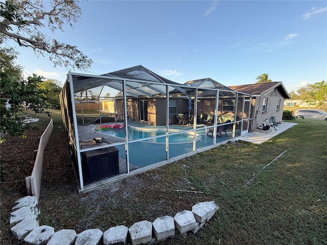 back of house with a lawn and glass enclosure